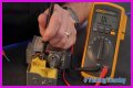 How do you test a Honeywell gas valve with a multimeter?